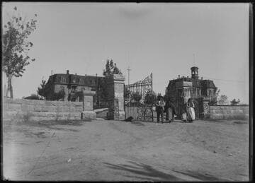 An Indian man, two women and a child standing at the main gate at the University of Nevada, Reno