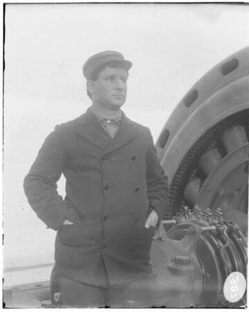 B.F. Pearson standing by a generator at Santa Ana River #1 Hydro Plant