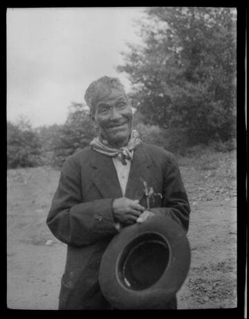 An unidentified Native American man holding hat