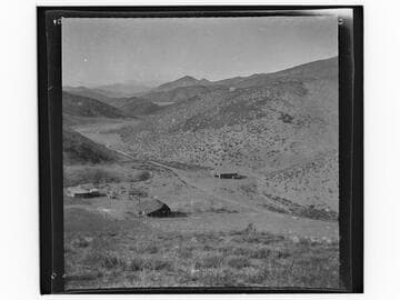 Landscape view of valley and ranch buildings