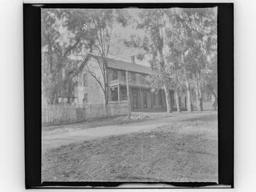 Unidentified two-story house with front balcony