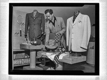 Interior view of men's store with merchandise and employee, Corrine Griffith Shop, Beverly Hills
