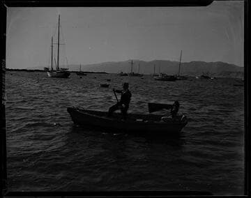 Man and a woman in a lifeguard boat off the Santa Monica coast