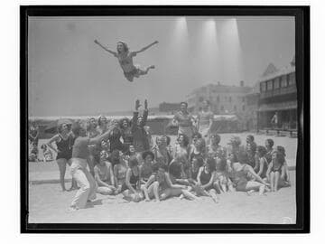 Woman tossed in the air on the beach, Santa Monica