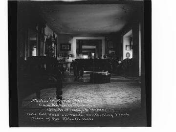 Parlor in Ranch House, San Antonio Rancho, Gov. H.T. Gage's home. Note tall vase on table, containing 7 inch piece of the Atlantic Cable