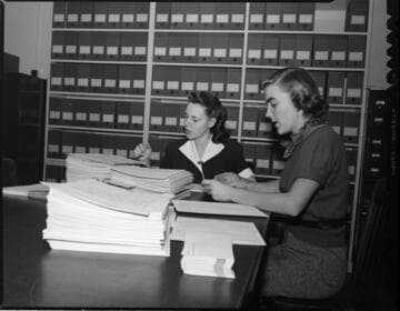Secretarial staff doing calculations and paperwork (with 2 variants)