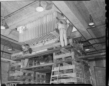 Lowering large piece of electrical equipment into underground vault