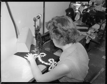 Seamstress sewing intricate embroidery with a special sewing machine