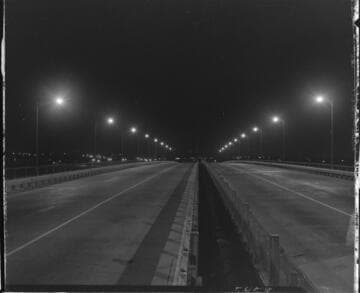Street lighting over a divided highway bridge