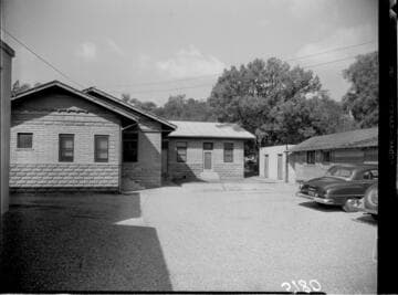 Cabin like building with cars parked in lot