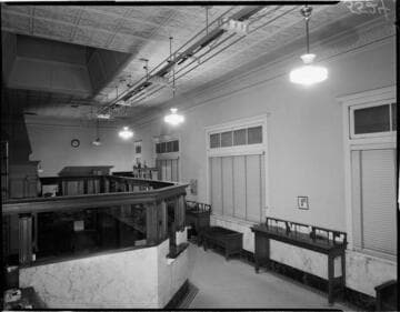 Bank teller counters with overhead florescent lights being installed