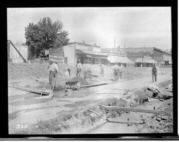 A construction crew mixing concrete for the construction of the Visalia Local Office Building