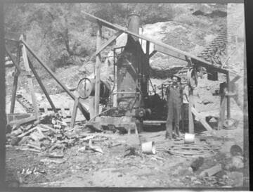 A construction crew next to the hoisting apparatus to hoist pipe up the pipe line at Kaweah #3 Hydro Plant