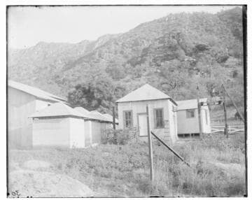 The switch house and transformer houses of Kaweah #1 Hydro Plant with the mountains in the background