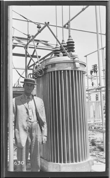 A man standing by a transformer at Tulare Substation