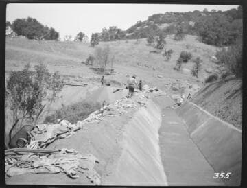 A construction crew plastering the ditch at the Tule Plant