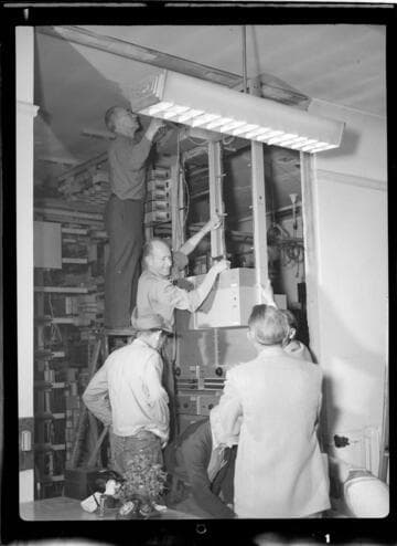Men assembling and installing electrical equipment