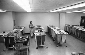 Men sorting deliveries in a room