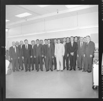 Men reviewing pamphlets for Sun City