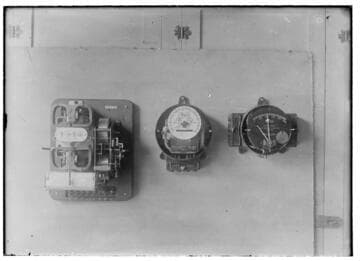 Three electric meters mounted in a group.  All are different designs
