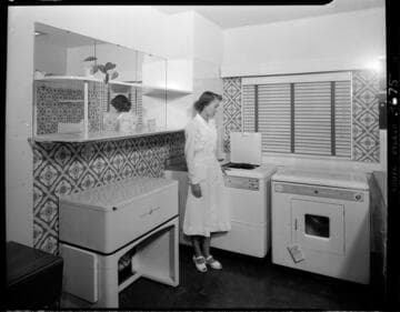 Woman with electric washer and dryier