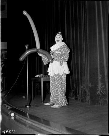 Clown with balloons on stage