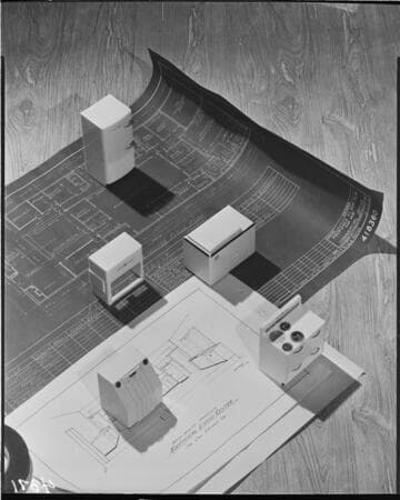 Residential construction plans with little plastic appliances placed on the drawing