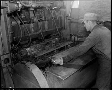 Man spotwelding metal pallets with machine