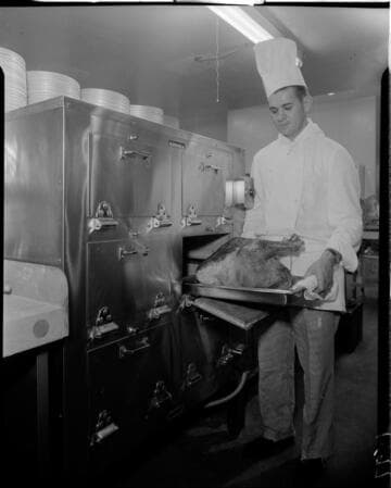 Chef removing turkey from oven