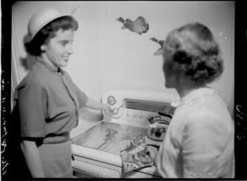 Two women talking by electric range