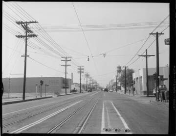 Street scenes on Santa Fe Ave. at 38th Street with electric rail and street lighting