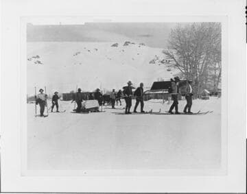 Rescue team carries Mrs. Mason from the destroyed powerhouse at Jordan Hydro Plant past the Mattley Ranch to Bodie