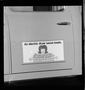 Poster-signs, displayed on Edison service vehicles, promoting electric home appliances