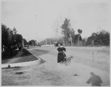 Figueroa Street North from Washington.  Mrs. Henry Hazard on wheel [bicycle]. 1900