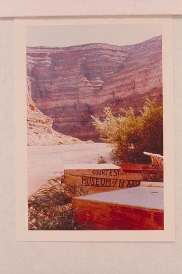 Jack Frost punts for San Juan trip of 1958, June.  The painted sign was to facilitate clearing the Glen Canyon Dam site in 1957