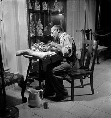 Attendant cleaning or repairing Chelsea porcelain in the Huntington residence