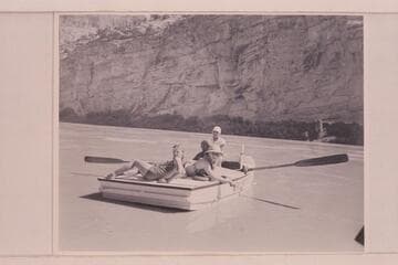 Nevills at the oars of the "WEN" in the lower end of Horseshoe Canyon.  Joan Nevills and Ros Johnson are on the stern while Al Milotte sits forward.  Note the "windmill recovery" of the oars characteristic of the Nevills technic