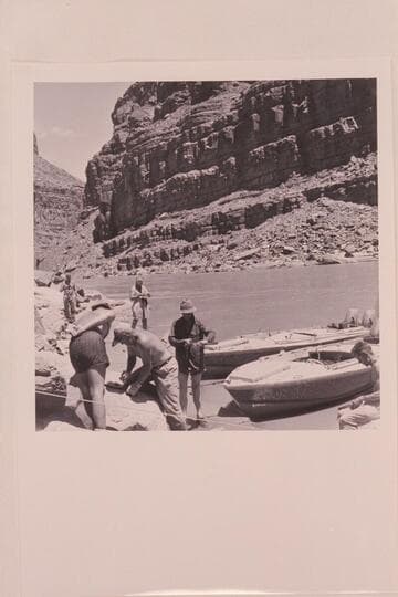 Replacing shields which were torn off the "BOOTOO" and the "CACTUS" in North Canyon Rapid.  Left to right in foreground:  Belknap, Sanderson, Taylor and Cutler.  In background:  Eisaman and Masland