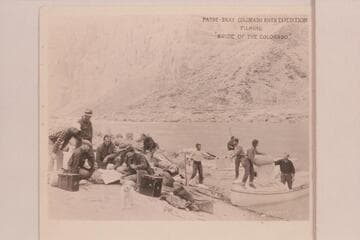 Pathe-Bray publicity photo 49.Frank Dodge wears the white cap at left.Leigh Smith kneels in front of Dodge.LaRue wears the checked shirt and kneels at left center.Pansy looks at the camera.Nick Samoff stands at the shore.Con Rodin is at right