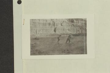 Stone's visit to Glen Canyon.  One man by a boat, two men pulling boat upstream