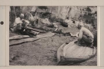 Dave Rust assembling his folding canvas boats.  George C. Fraser watches at left