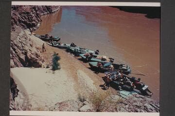 Seven boats of Marston-Disney fleet moored below skeleton above Paradise Canyon