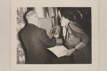 Dock Marston examines a photo of Robert Brewster Stanton while Anne Stanton Burchard looks on; Kings Gap
