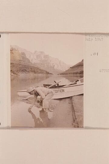 Randall Henderson measuring river temperature; Nevills Grand Canyon party of 1947, July