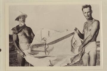 Cropped photo of Dock Marston and Norm Nevills holding the rubber raft found during the 1948 traverse of the Grand Canyon.  The raft was found near Mile 220