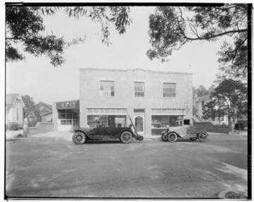 Two cars parked in front Eddie Motors auto repair shop, 55 Waverly Drive, Pasadena. 1925