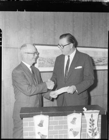 Executives posed exchanging checks